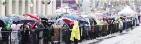  ?? DARREN BROWN / POSTMEDIA NEWS ?? Thousands of people lined up for hours in the pouring rain for security checks near Parliament Hill in Ottawa during a Canada Day celebratio­n that some called a “fiasco.”