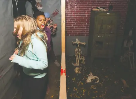  ?? KAYLE NEIS ?? Abebayehu Pahl, centre, and friends scream while exploring one of Saskatoon’s haunted houses. As Halloween approaches, a number of events have been put on for the brave, and not so brave.