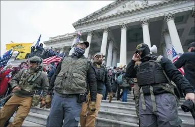  ?? MANUEL BALCE CENETA — THE ASSOCIATED PRESS FILE ?? Members of the Oath Keepers stand on the East Front of the U.S. Capitol on Jan. 6, 2021. Federal prosecutor­s on Monday began to lay out their case against the founder of the Oath Keepers’ extremist group and four associates charged in the most serious case to reach trial yet in the Capitol attack.