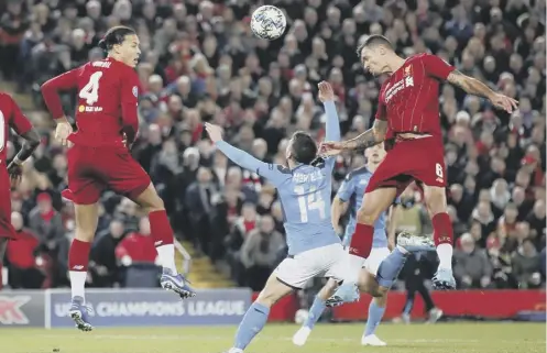  ?? PICTURE: MARTIN RICKETT/PA ?? 0 Dejan Lovren rises above the Napoli defence to head home Liverpool’s second-half equaliser.