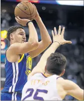  ?? RICK SCUTERI — THE ASSOCIATED PRESS ?? Warriors guard Klay Thompson was in a good shooting rhythm in a 117-100 win over Phoenix on Sunday night.