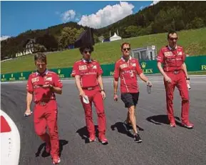  ??  ?? Ferrari’s Sebastian Vettel (third from left) inspects the track at the Red Bull Ring circuit in Spielberg, Austria yesterday. EPA PIC