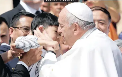  ?? EMO CASILLI Reuters ANA ?? FAITHFUL PRAISED
POPE Francis greets a child from China at the end of the weekly general audience at the Vatican. |