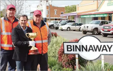  ??  ?? Racing royalty and Emirates Melbourne Cup Tour Ambassador John Marshall with local railway workers in Binnaway.