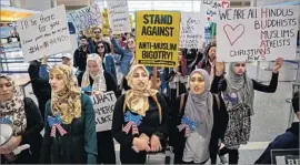  ?? Marcus Yam Los Angeles Times ?? PROTESTERS this year gathered at LAX and other major airports after Trump signed the order, which restricts travel from six Muslim-majority countries.