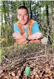  ?? PHOTO: FAIRFAX NZ ?? Perrin Brown looks at a poison 1080 pellet, one of many he says he found on and off a track between Supply Bay and Balloon Loop which is outside DOCs 1080 drop zone in the Kepler mountains.