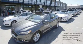  ?? — Reuters ?? A fleet of Uber cars is shown during a demonstrat­ion of self-driving automotive technology in Pittsburgh.