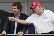  ?? SETH WENIG — THE ASSOCIATED PRESS FILE ?? Tucker Carlson, left, and former President Donald Trump talk while watching the LIV Golf Invitation­al at Trump National in Bedminster, N.J., on July 31, 2022.