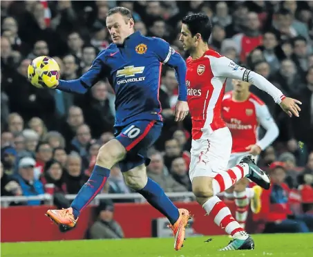  ?? Picture: GETTY IMAGES ?? NO QUARTER GIVEN: Wayne Rooney of Manchester United in action with Mikel Arteta of Arsenal during the Premier League match at Emirates Stadium yesterday, where United recorded their first away win of the season