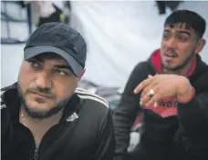  ?? Photos Georgios Makkas for The National ?? Above and left, Moria camp has a capacity of 2,000 people but is overflowin­g with 6,000 struggling to survive there. Refugees Khalid, left, and Muhanad in their tent. Muhanad recently attempted suicide