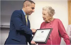  ?? KASSI JACKSON/HARTFORD COURANT/TNS ?? Veterans Affairs Commission­er Thomas Saadi presents Alice Johnson, 93, with a certificat­e in recognitio­n of her service during WWII in the United States Cadet Nurse Corps.