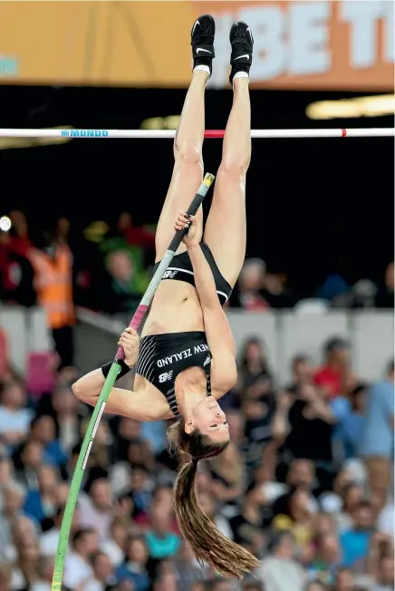  ?? PHOTOSPORT ?? Eliza McCartney competes in the pole vault qualifying round at the World Championsh­ips in London yesterday.