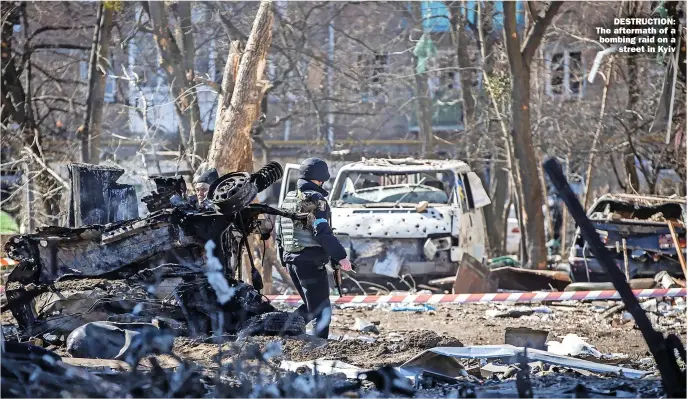  ?? ?? DESTRUCTIO­N: The aftermath of a bombing raid on a
street in Kyiv