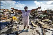  ?? AL DIAZ/MIAMI HERALD VIA AP ?? Aliana Alexis, of Haiti, stands on the concrete slab of what is left of her home after destructio­n from Hurricane Dorian in an area called “The Mud” at Marsh Harbour in Great Abaco Island, Bahamas, on Thursday.