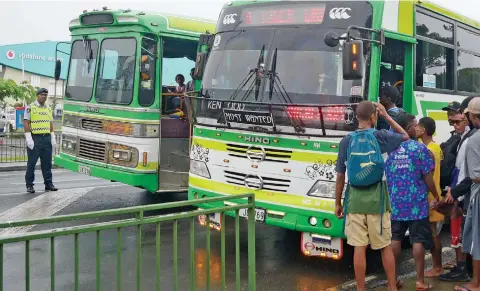  ?? Ronald Kumar ?? Police Constable Timoci Dakuna (left) ensuring students safety in buses outside the HFC Bank Stadium following the Suva Zone 1 on April 18, 2023. Photo: