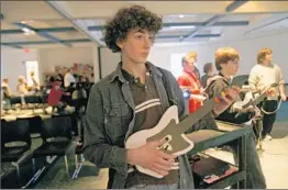  ?? Kimberly P. Mitchell Associated Press ?? LUKE DANIELS plays in a 2008 “Guitar Hero” competitio­n in Rochester, Mich.