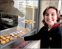  ?? Rick Steves’ Europe/RICK STEVES ?? A happy visitor chooses a “pastel de nata” at a bakery in Portugal.