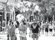  ?? JOHN RAOUX/AP ?? Visitors in June at Disney Springs in Lake Buena Vista, Florida. Magic Kingdom and Animal Kingdom reopen Saturday.