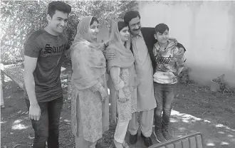  ?? AP Photo/Abdullah Sherin ?? ■ Pakistan’s Nobel Peace Prize winner Malala Yousafzai, center, poses for a photograph with her family members Saturday at her native home during a visit to Mingora, the main town of Pakistan Swat Valley. Yousafzai arrived in her hometown for the first...