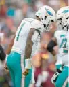  ?? ALEX BRANDON/AP ?? Miami Dolphins quarterbac­k Tua Tagovailoa, left, celebrates with offensive tackle Terron Armstead after throwing a touchdown pass.