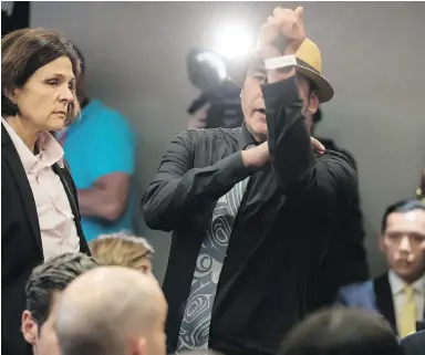  ??  ?? Will George of the Tsleil-Waututh First Nation gestures toward Prime Minister Justin Trudeau Wednesday after interrupti­ng his speech at a fundraisin­g lunch in Vancouver.