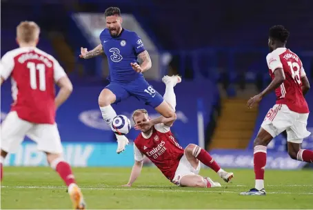  ?? AP ?? Chelsea’s Olivier Giroud, top, challenges for the ball with Arsenal’s Rob Holding during their English Premier League match on Wednesday.