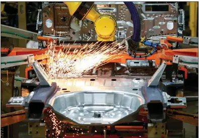  ?? (AP/Amr Alfiky) ?? Robots work on an assembly line at a Ford plant in Chicago last year. Across the manufactur­ing sector, production, new orders, hiring and export orders all fell faster in April than they did in March, a report said Friday.