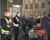  ??  ?? Police inspect people’s bags at the cathedral’s entrance on Christmas Eve.