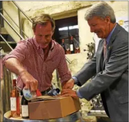  ?? ANNE NEBORAK — DIGITAL FIRST MEDIA ?? Chris Le Vine and state Sen. Tom Killion package up the first bottle of wine that is being shipped to Josie Maran.