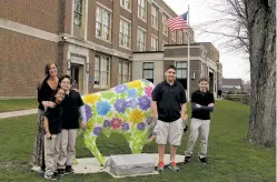  ?? CAROLYN THOMPSON/ASSOCIATED PRESS FILE PHOTO ?? From left, teacher Kelly Gasior and students Olivia Mashtaire, Ryan Lysek, Christian Vazquez and Tyler Lysek stand with a statute of a buffalo emblazoned with anti-bullying messages outside of Lorraine Academy in Buffalo, N.Y. One in every 5 middle and high school students has complained of being bullied at school, according to a study.