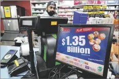  ?? GENE J. PUSKAR/AP ?? A MEGA MILLION SIGN DISPLAYS the estimated jackpot of $1.35 Billion at the Cranberry Super Mini Mart in Cranberry, Pa., on Jan. 12.