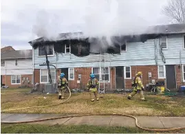  ?? ANNAPOLIS FIRE/COURTESY PHOTO ?? Three families were displaced from their Robinwood town homes after a fire ignited from a cigarette ember and spread across three units. A resident suffering smoke inhalation was transporte­d to a local hospital, along with a firefighte­r who had minor burns.