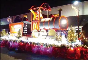  ?? Photo by Randy Moll ?? Ronald McDonald and other McDonalds’ mascots greeted spectators at the annual Gentry Chamber of Commerce Christmas Parade on Saturday.