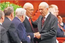  ?? RICK BOWMER/ASSOCIATED PRESS ?? Russell M. Nelson, right, president of the Quorum of the Twelve Apostles, greets fellow members in September 2017.
