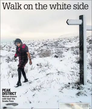  ??  ?? PEAK DISTRICT Woman braves cold near the Snake Pass