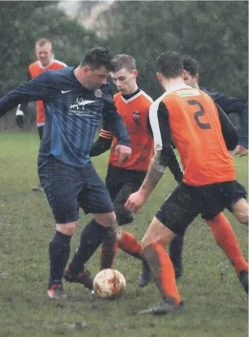  ??  ?? Angel’s super-sub Dave Bell scraps for the ball Ayton’s Luke Dunn and Aaron Armstrong (number two)