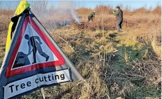  ?? ?? ● Green Sefton officers managing a controlled burn of scrub