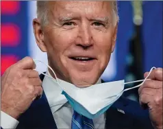  ??  ?? Joe Biden takes his face mask off to speak in Wilmington, Delaware