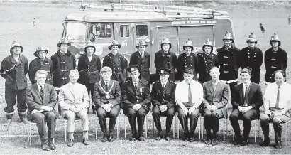  ?? PHOTO: SUPPLIED ?? Full brigade . . . The Queenstown Volunteer Fire Brigade pose on the recreation ground after taking delivery of the TK Bedford fire appliance in the late 1960s. Mr Robertson is pictured in the back row, fifth from the left. Former mayor Warren Cooper is in the front row, third from the left.