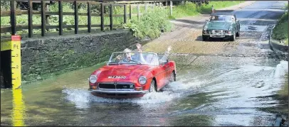  ??  ?? An MGB V8 negotiates a ford near Rufford Abbey, as more than 90 classic and sports cars recently gathered at Quorn and Woodhouse Station on the Great Central Heritage Railway to take part in The 2018 Charnwood Caper Run.