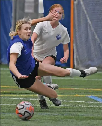  ?? CHRIS CHRISTO — BOSTON HERALD ?? Weymouth MA - January 21, 2024: Emily Mara heads to the turf after competing for the ball with Georgie Clarke during the ASFL Soccer Courage Cup.