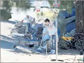  ??  ?? A homeless woman sweeps her living area in the homeless encampment. Earlier, San Jose city councilman Tam Nguyen took Caltrans to task for not addressing the growing homeless encampment.