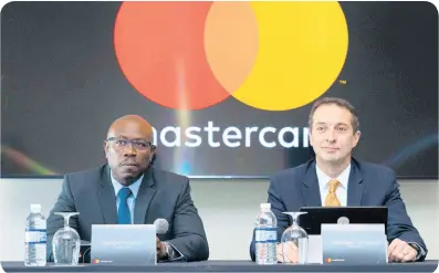  ??  ?? Mastercard Jamaica Country Manager Dalton Fowles (left) and Mastercard Caribbean Division President Marcelo Tangioni speak at a press conference to announce that Mastercard has set up office in Jamaica on October 15, 2019, at the AC Kingston Hotel in New Kingston.