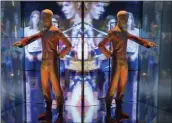  ?? JOEL RYAN — INVISION/AP ?? A reflection of the costume that David Bowie wore as Ziggy Stardust on tour.