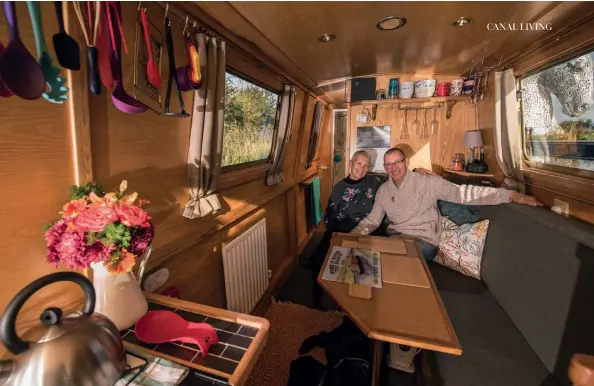  ??  ?? Above: The interior of Becca and Ray’s boat is cosy and welcoming. Below: Boats moored in front of the residents’ storage sheds at Causewayen­d Marina in Linlithgow.