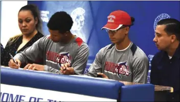  ??  ?? Thadeo Campbell and Joseph Tarango sign their National Letters of Intent to play football for Colorado State University — Pueblo in the Central Union gym on Wednesday morning. PHOTO AARON BODUS