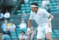  ?? AP PHOTO/BEN CURTIS ?? Milos Raonic returns the ball to John Isner during their men's quarterfin­als match at the Wimbledon Tennis Championsh­ips, in London, Wednesday.