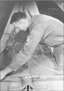  ?? ?? Back in 1958 each member of the team did it all, they were riggers, packers, and jumpers. pictured here is sgt 1st Class Williamson preparing his chute for another free-fall exercise.