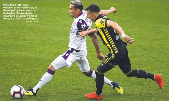  ?? Picture: GETTY ?? PRESSURE’S ON: Jason Davidson of the Perth Glory is challenged by Louis Fenton of Wellington Phoenix during yesterday’s A-League match at Westpac Stadium in Wellington.