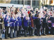  ?? (Ed Sykes/Reuters) ?? PEOPLE GATHER outside Bolton Town Hall as King Charles arrives at Victoria Square on Friday.